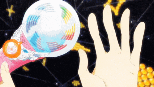 a person 's hand is reaching out towards a toy that looks like a globe