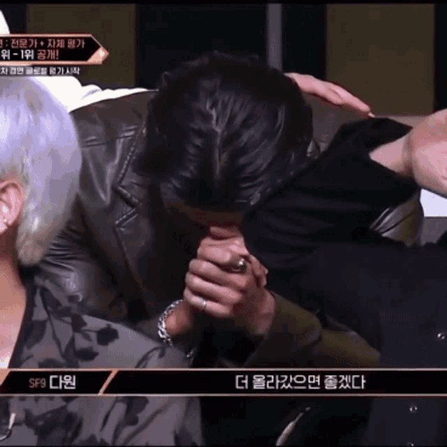 a man with a ring on his finger is praying in front of a sign that says sf8
