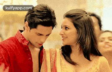 a man and a woman are looking into each other 's eyes .