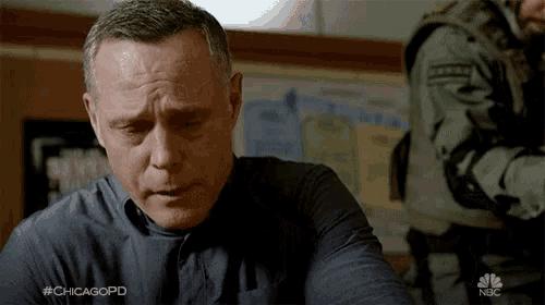 a man sitting in front of a bulletin board with #chicagopd on it