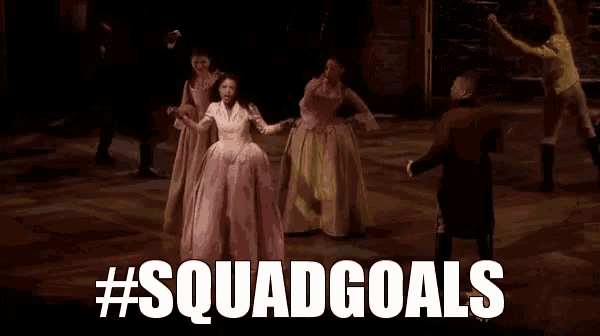 a group of people are dancing on a stage with the words `` squad goals '' written on the bottom .
