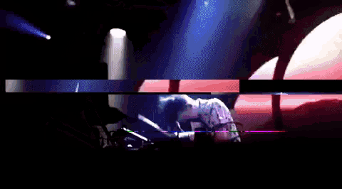 a man is playing a keyboard in a dark room