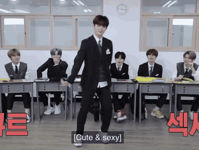 a man in a suit and tie is dancing in front of a group of boys in suits