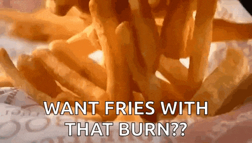 a close up of a pile of french fries with the words `` want fries with that burn ? ''