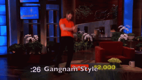a man is dancing in front of a sign that says gangnam style on it