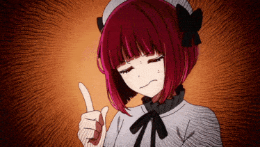 a girl with red hair is making a funny face and pointing her finger