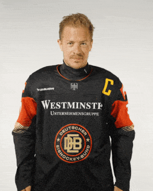 a man is wearing a jersey that says westminster on the front