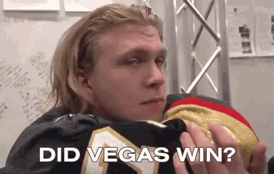 a man holding a jersey that says did vegas win on it