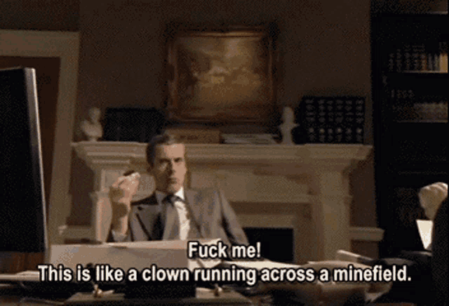 a man in a suit and tie says " fuck me "