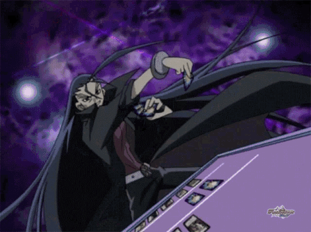 a man in a black cape is holding a card in his hand in front of a screen that says yu gi oh