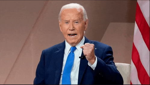 a man in a suit and tie is pointing at something