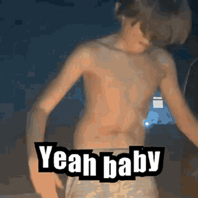 a shirtless boy is dancing with the words `` yeah baby '' written on his chest .