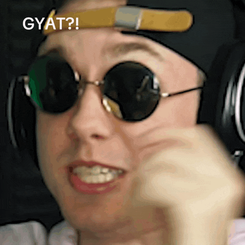 a man wearing sunglasses and headphones is making a funny face and the caption says gyat