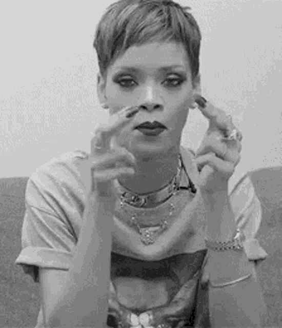 a black and white photo of a woman with short hair making a face