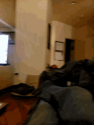 a person 's feet are visible in a blurry photo of a room