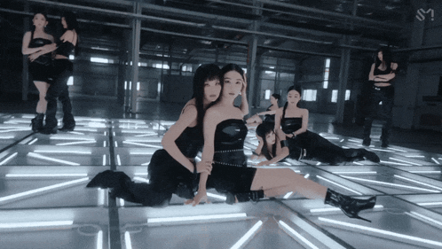a group of women are posing for a photo with the letter s on the bottom