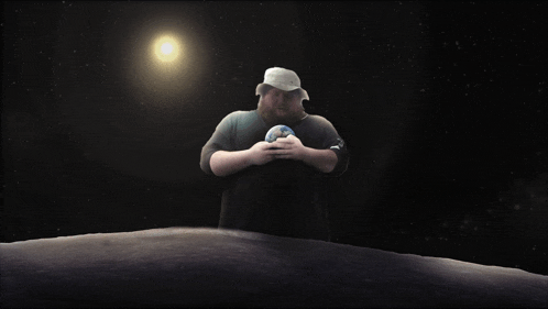 a man holding a globe in his hands in front of a bright sun