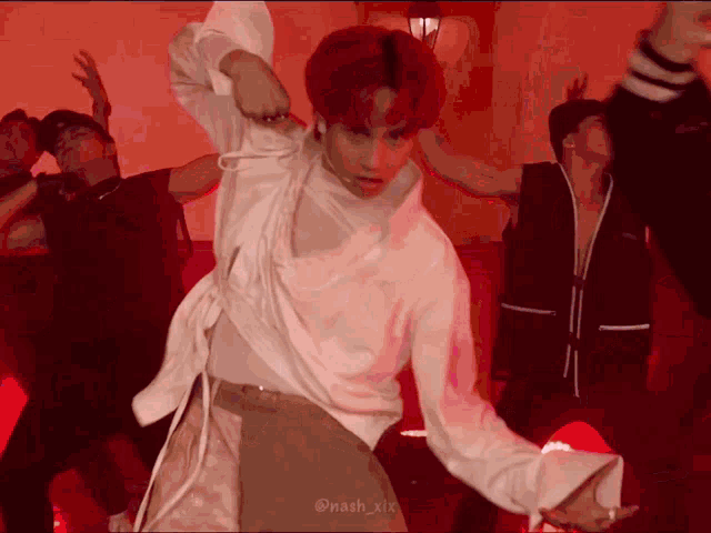 a man with red hair is dancing in a group