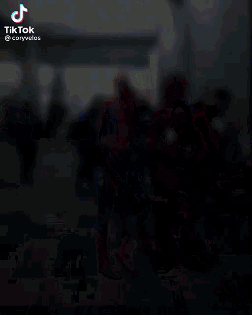 a group of people in superhero costumes are standing in a dark room with tiktok written on the bottom right corner