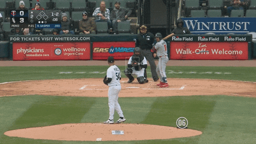 a baseball game is being played on a field with ads for wellnow gas n mask and physicians