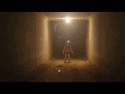a person standing in a dark tunnel with a light on
