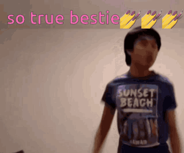 a boy wearing a sunset beach shirt stands in front of a wall