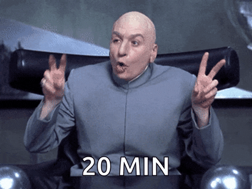 a bald man sitting in a chair giving a peace sign with the words 20 min below him