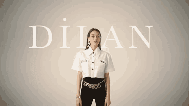 a woman stands in front of a wall with the word dilan on it