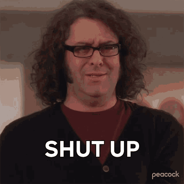 a man with curly hair and glasses says shut up on a peacock screen