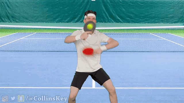 a man is playing tennis on a blue court with the twitter / @ collinskey watermark