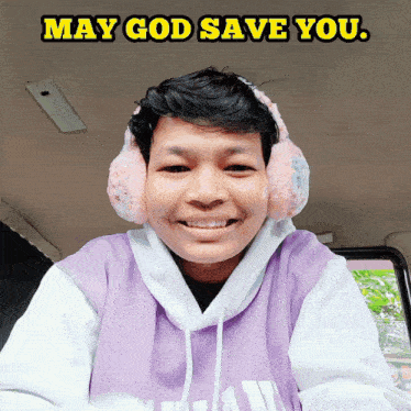 a man wearing ear muffs and a purple hoodie with the words may god save you above him