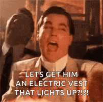 a man in a suit and tie is screaming and saying `` let 's get him an electric vest that lights up ! ''