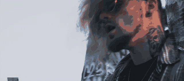 a man with a tattoo on his neck is wearing sunglasses .