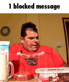 a man in a red shirt is sitting at a table with a box of ice cream and a carton of milk