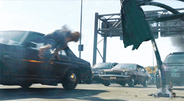 a man is jumping over a car with a license plate that says nj