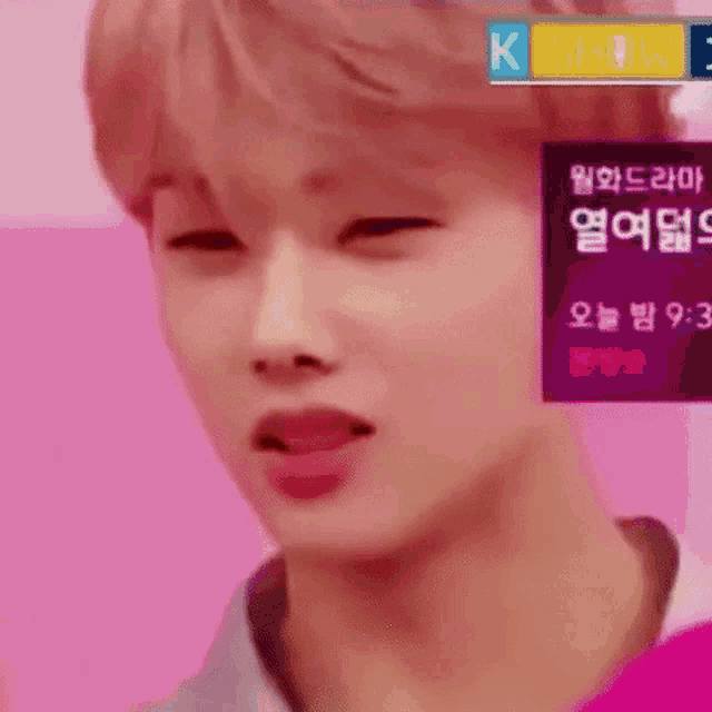 a close up of a person 's face with a pink background and a sign that says k show .