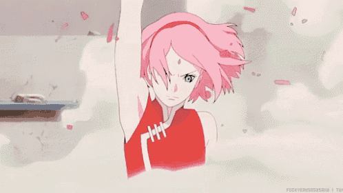 a girl with pink hair and green eyes is standing in a room with her arm up .