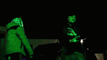 a blurry image of a person in a purple and green outfit