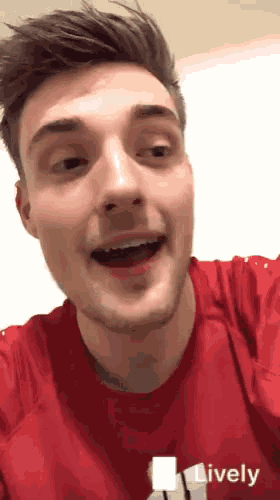 a man is wearing a red shirt with the word lively on it