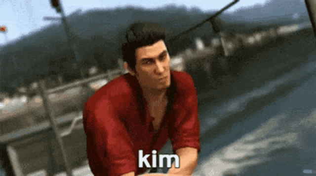 a man in a red shirt says kim in front of a body of water ..