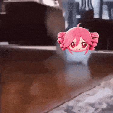 a pink stuffed animal with curly hair and red eyes is floating in the air
