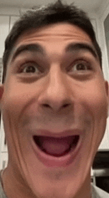 a man is making a funny face with his tongue out .