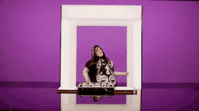 a woman is standing in a white box on a purple background