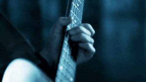 a close up of a person playing a guitar