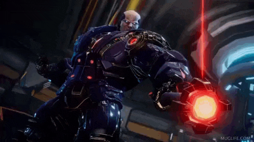 a man in a futuristic suit is holding a red object in his hand .