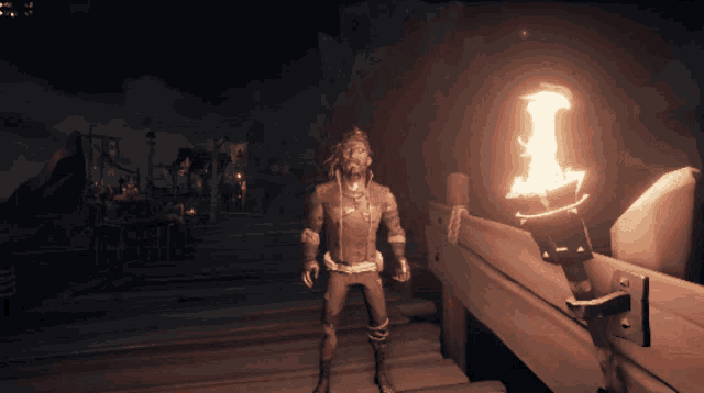 a video game character standing next to a lit torch