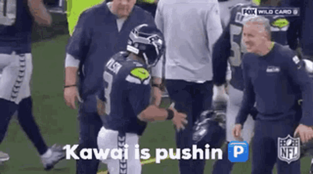 a football player is talking to another player on the field and the words kawai is pushin p are visible .