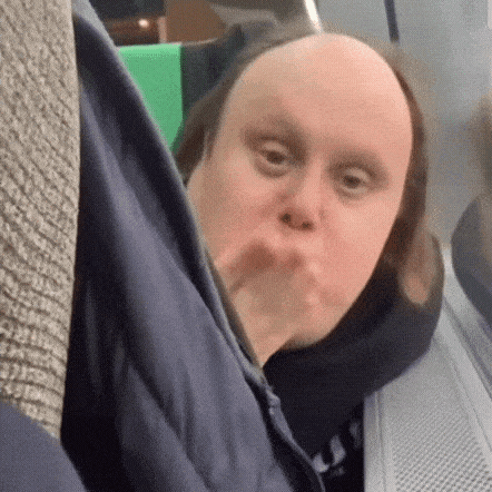 a man with a bald head is sitting on a bus .