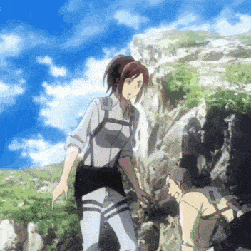a man and a woman standing next to each other on a rocky hillside