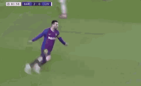 a soccer player is sitting on the ground on the field .